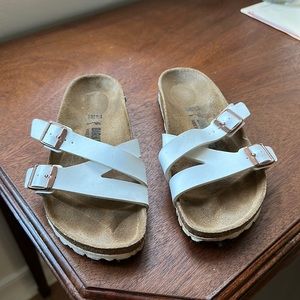 Sold out white Birkenstocks sandal with two white straps and rose gold buckles